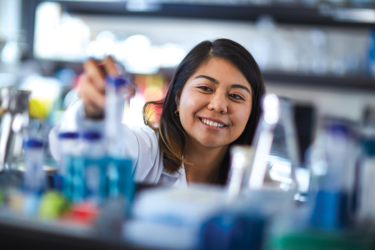 San Francisco State University student reaching for a test tube
